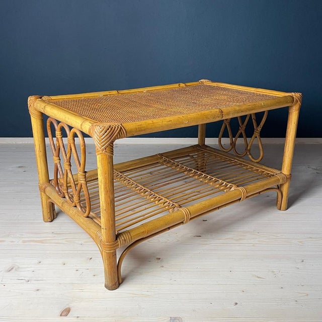 Enhance your living space with this exquisite vintage rattan coffee table, hailing from the 1970s and crafted in the heart...