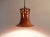 Very beautiful 1970s pendant light. The shade is made of orange glazed ceramic with some red and black. The hole structure...