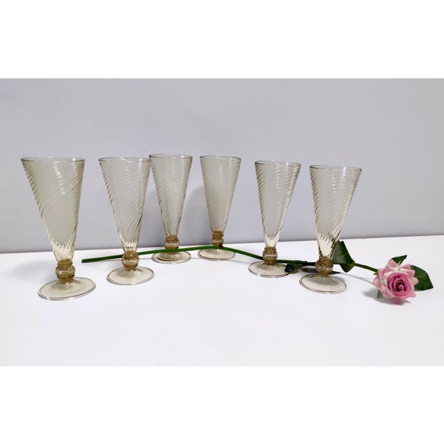 Made in Italy, 1930s. They are in Murano glass and have particles of coal that are included in the glass due to their...