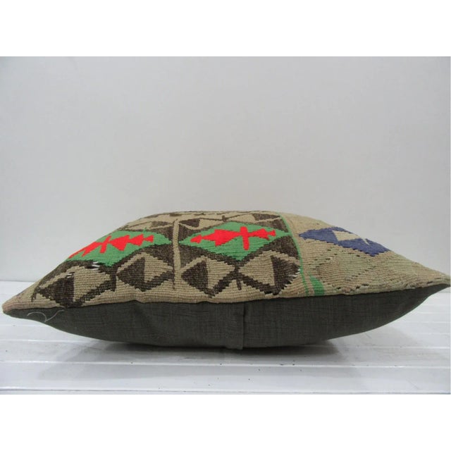 This is a pillow cover made from a vintage kilim rug. The piece was properly washed and ready to use. Pillow inserts not...