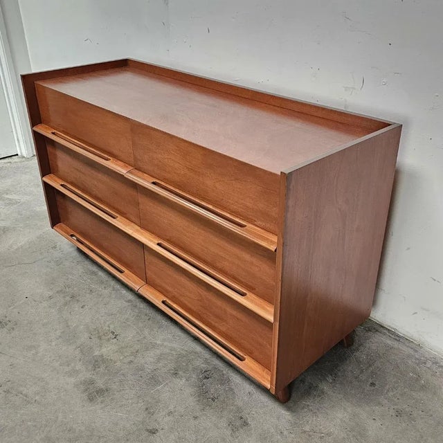 Edmond Spence dresser with six dovetailed drawers and sculpted pulls. Mid-Century Modern masterpiece with a distinctive...