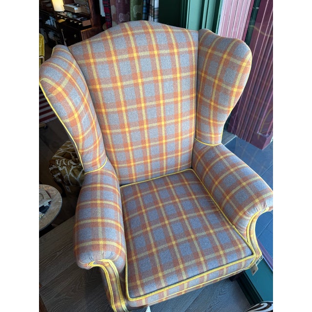 This classic wingback armchair combines timeless traditional craftsmanship with warm contemporary character, creating an...