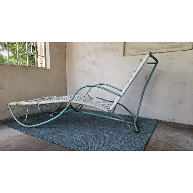 An elegant vintage chaise lounge attributed to Walter Lamb, featuring a tubular bronze frame and woven nautical rope...