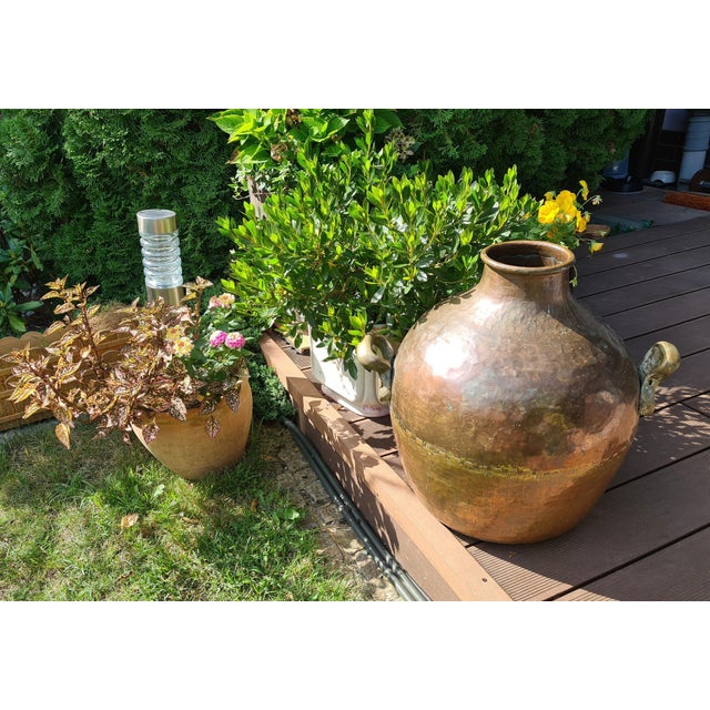 An impressive, large vessel made of hand-hammered copper, originating from Egypt. Its distinctive, spherical shape—with a...