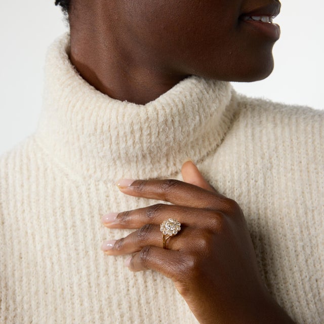 A magnificent example of late Victorian craftsmanship, this antique cluster ring centers on a striking 2.23 carat old...