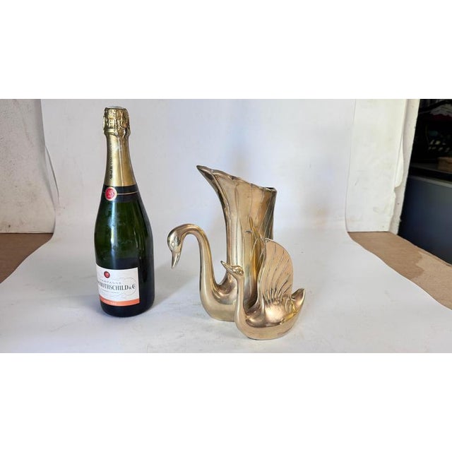 This is a French decorative brass vase from the 1970s, designed as a sculpture of two swans. The body of one swan...