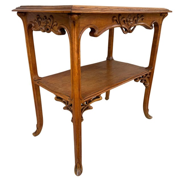 Magnificent Art Nouveau walnut side table in the style of Emilie Gallé. Foliage and branch motifs.