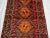 This exceptional vintage Afghan hand-knotted wool rug displays a powerful tribal geometric medallion design in vibrant...