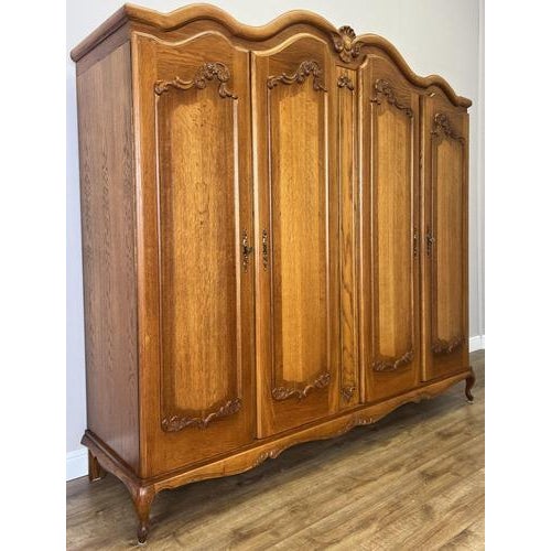 This elegant Vintage French Louis wardrobe features beautifully carved decorative panels, graceful shaping, and a refined...