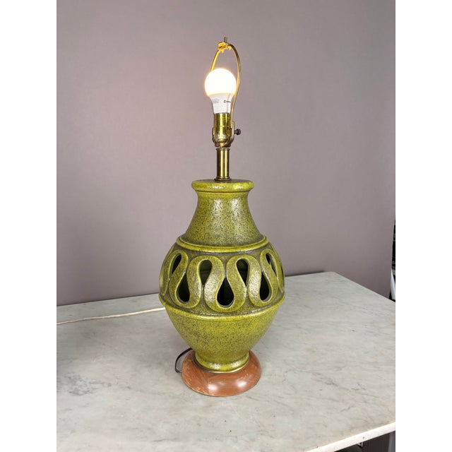 Ceramic green textured pottery decorative lamp with teak wood base. Working condition corded electric. Dimensions: Vase:...