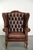 This beautiful brown English-style Chesterfield wingback chair is made of cowhide leather and offers a comfortable seat....