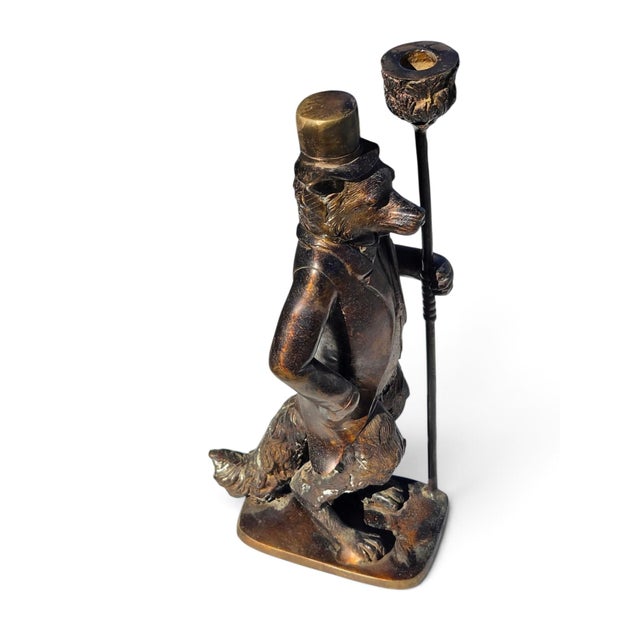 This striking decorative sculpture features a fox- or dog-headed gentleman wearing a tall top hat, a tailored Victorian-...