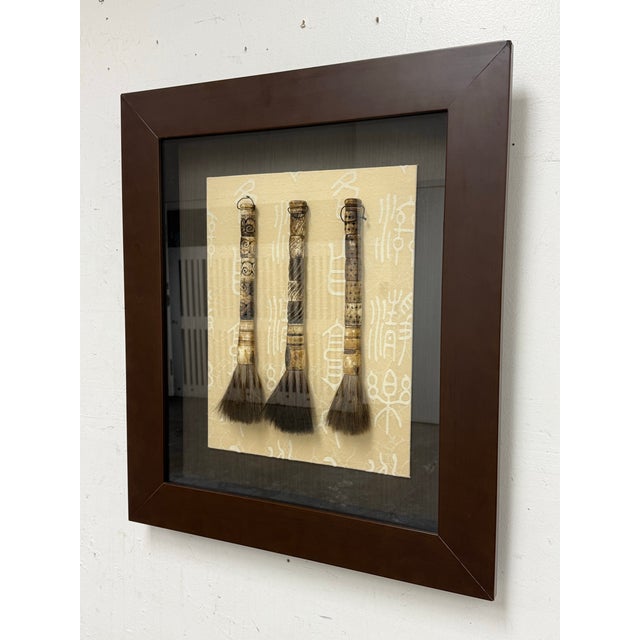 Design Plus Gallery presents a Framed Chinese Ox Bone Calligraphy Brush Pen Shadowbox Wall Art. This wall art showcases...