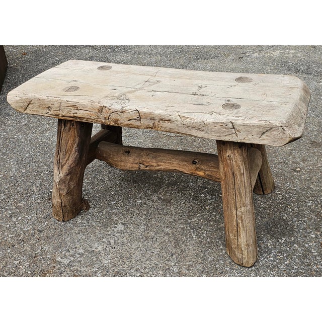 An Early American Style Rustic Stretcher Pine Log Bench. Measures 35" in width, 17" in depth and 17.5" in height.