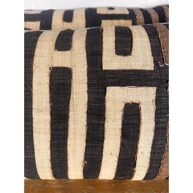 A striking pair of decorative pillows crafted from authentic vintage Kuba cloth textiles from Central Africa. The fronts...