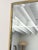 A vintage wall mirror with a brassed metal frame emulating bamboo. This original mid century rectangular mirror has a...