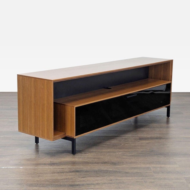 This BDI console features a modern design with a walnut wood finish and a sleek black glass front. The unit includes a...