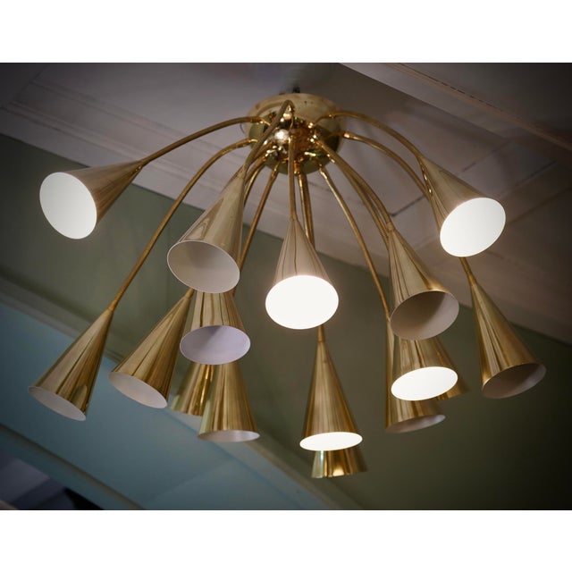 Truly incredible design for this chandelier from the 70s, due to the very particular shape of these long brass rods which...