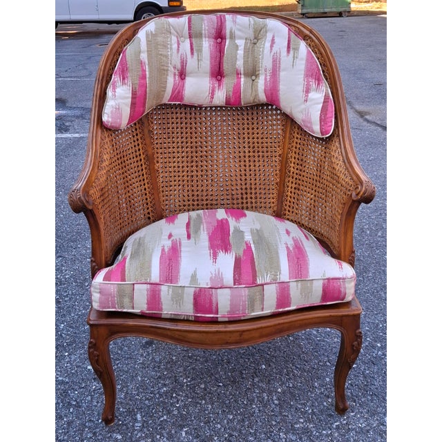 An Italian made French Louis XV Style Double Wall Caned and Upholstered Bergère Armchair. Removable cushions may easily...