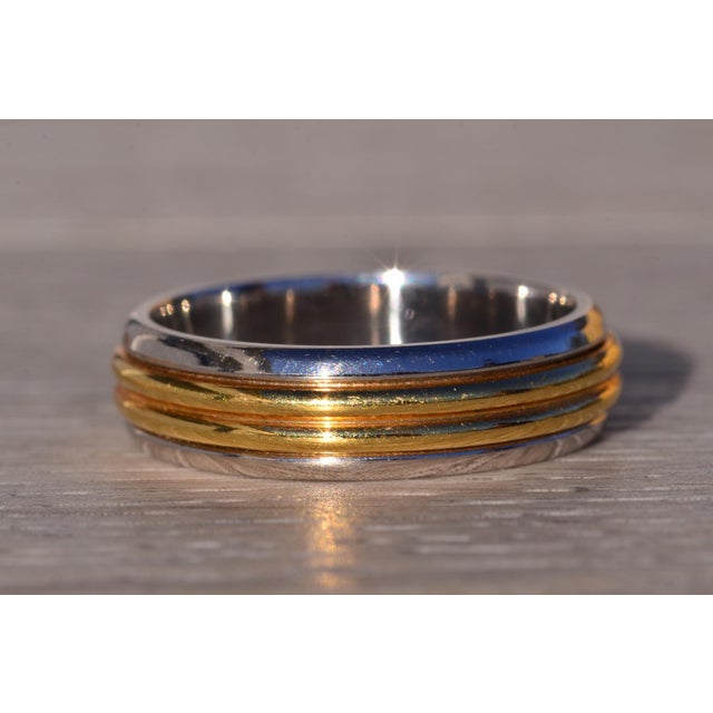 The Panda: Handmade Platinum and Yellow Gold Band. This band showcases a central double dome in 18 karat yellow gold,...