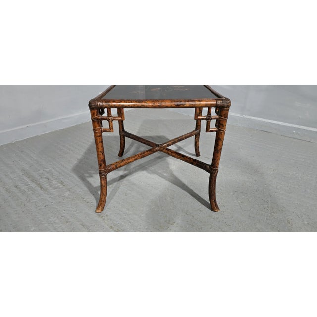 Very good black laquered and bamboo occasional table with painted goldfish to the top, in overall very good condition. 19"...