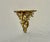 Vintage Italian giltwood wall bracket shelf, features hand-craved wood, rococo style foliate scrolls and a gold gilded...