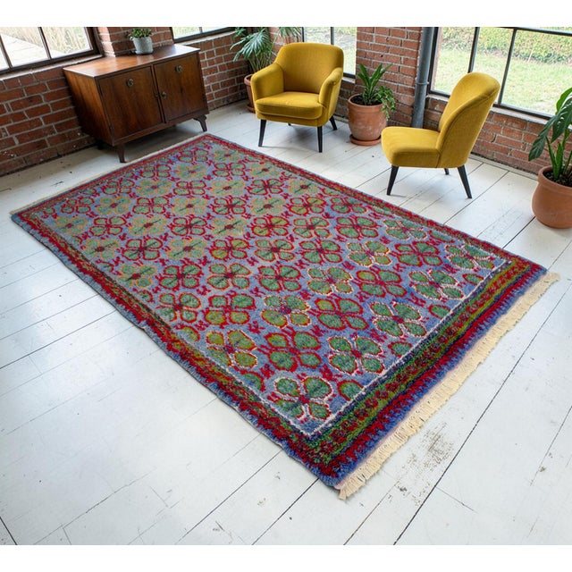 Hand-knotted on a traditional village loom in Aegean Anatolia, this striking 1940s Oushak rug showcases exceptional...