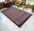 Hand-knotted on a traditional village loom in Aegean Anatolia, this striking 1940s Oushak rug showcases exceptional...