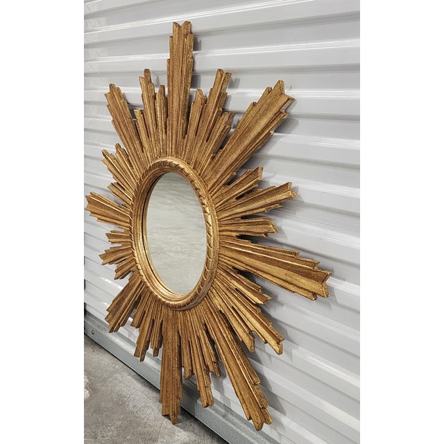 Stunning Italian handpainted carved Giltwood sunburst mirror, with radianting ray design. Design to elevate your decor,...