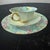 A stunning example of the coveted "Melody" chintz pattern. This trio includes a fluted teacup with an interior floral...
