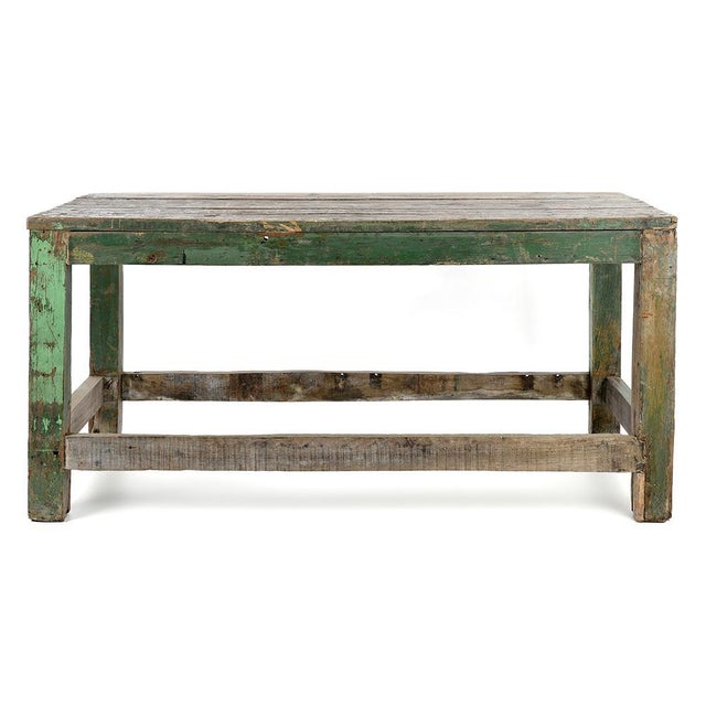 This solid wood workshop table seduces with its chipped green patina, evoking natural wear and the history of a piece of...