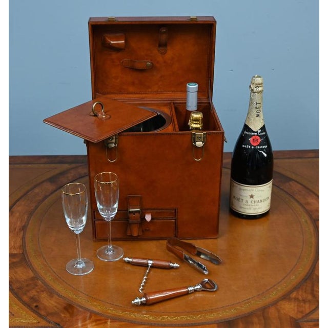 Stylish fitted leather champagne and wine hamper Finished in rich tan leather with contrasting brass fittings Hinged lid...