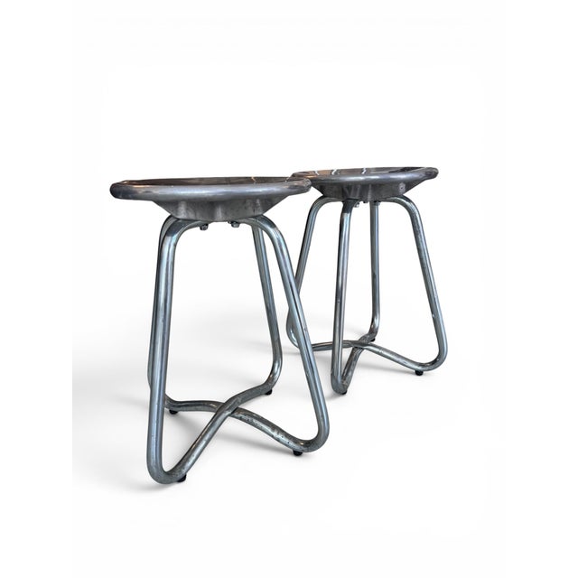 An original pair of aluminium stools or side tables designed by Terence Conran for The Conran Shop in the 1990s,...