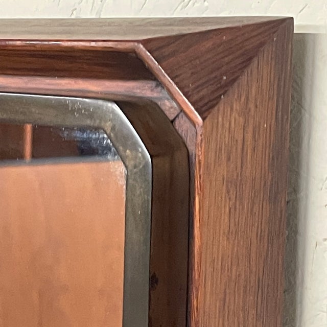 Rectangular wall mirror, typical of 1950s Italian modernism, produced by the Consorzio Esposizione Mobili Cantù, a key...