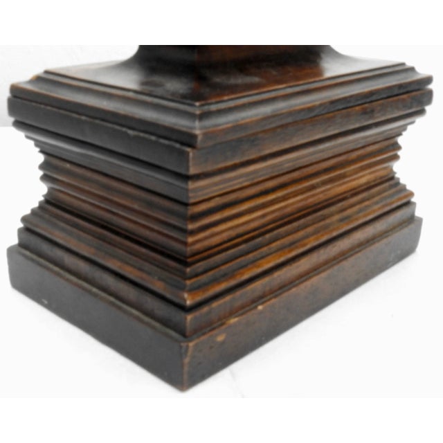 A vintage handcrafted stained walnut box. The rectangular box has a beveled design with a hinged lid over storage. A...