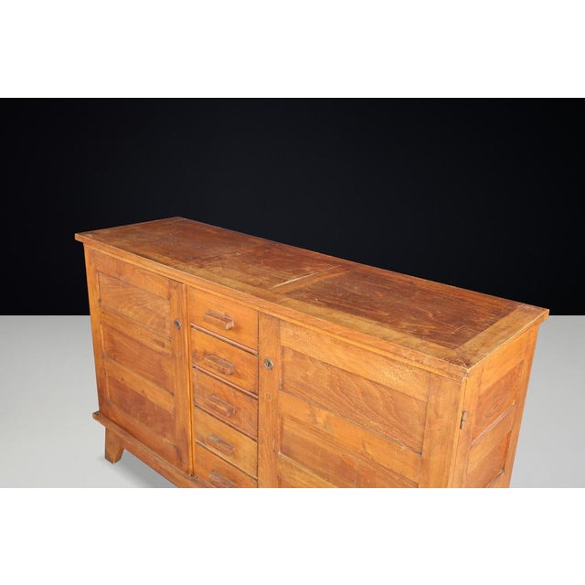 This mid-century sideboard, made from patinated French oak, was designed by René Gabriel in the 1940s in France. It was...