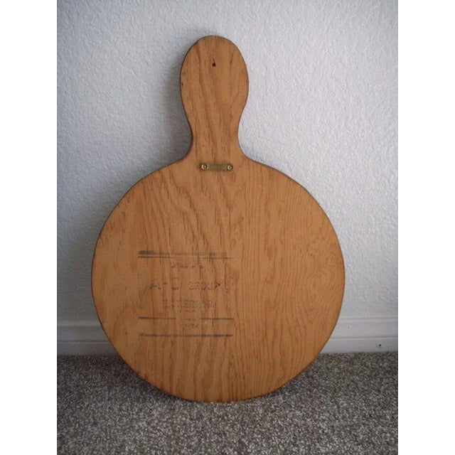 A vintage Dutch Folk Art decorative cutting board featuring a hand-painted scenery of a Dutch boy and girl watering...