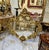 Stunning vintage French Baroque wall mirror featuring an exceptionally ornate frame adorned with elaborate botanical...