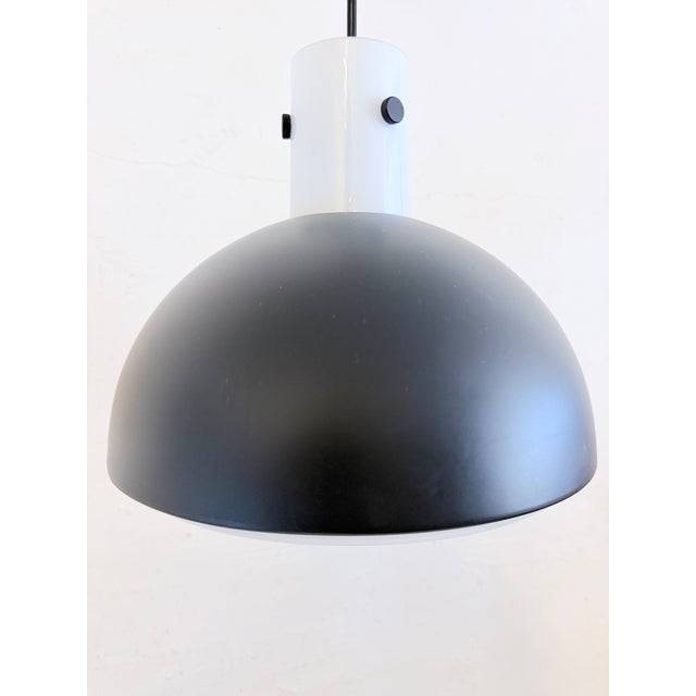 One pendant lamp from the 1970s or 80s. White glass, black lacquered metal. Good used condition. Some scratches on the...