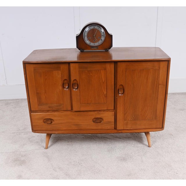 A stylish oak Mid Century Modern sideboard by Ercol, dating to around 1960 The cabinet displays beautifully figured solid...