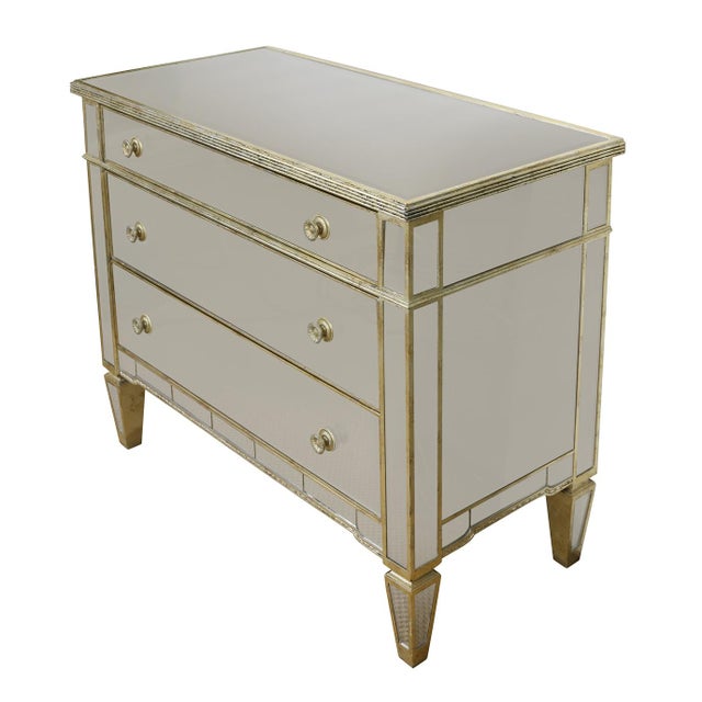 A Regency style mirrored three drawer chest with gilt trim. A timeless statement piece that blends classic sophistication...