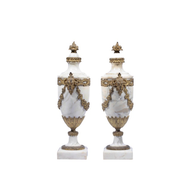 A Pair of French Antique White Marble Ormolu Mounted Cassolettes, urn shaped with ormolu mounts of rams head and acanthus,...