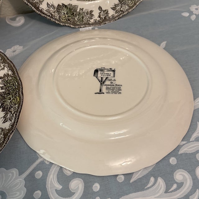 Bring classic English countryside charm to your table with this **set of 4 Vintage Johnson Brothers “Friendly Village”...