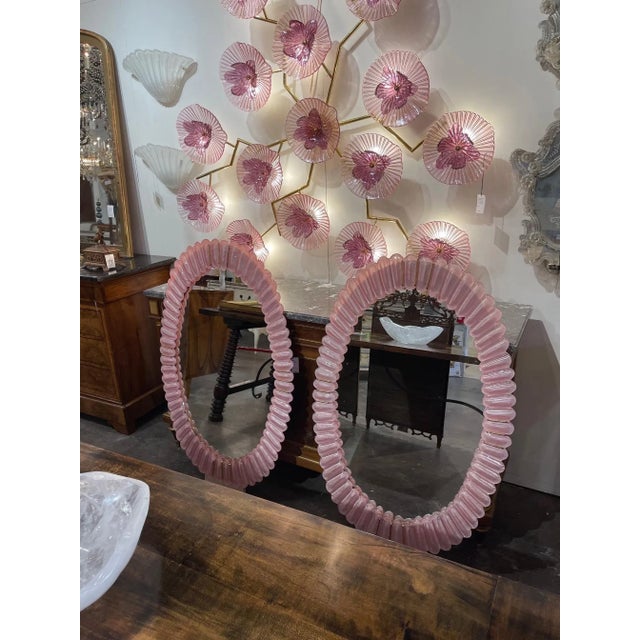 Fabulous oval shaped pink Murano glass mirrors. Gorgeous pink glass with brass accents. An amazing decorative accent!!...