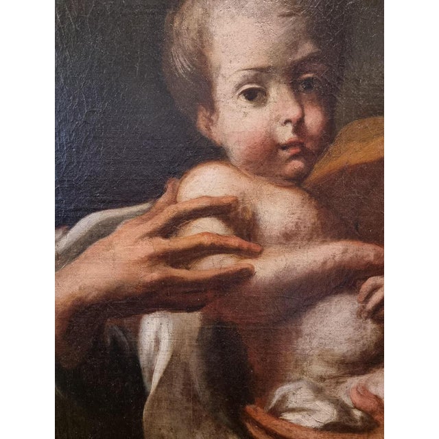 The painting represents Saint Joseph in a moment of deep contemplation, with his gaze turned upwards, as if he were...