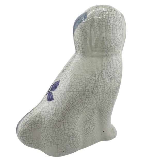 A charming Delft-style or Staffordshire-style ceramic spaniel dog figure decorated in cobalt blue floral motifs against a...