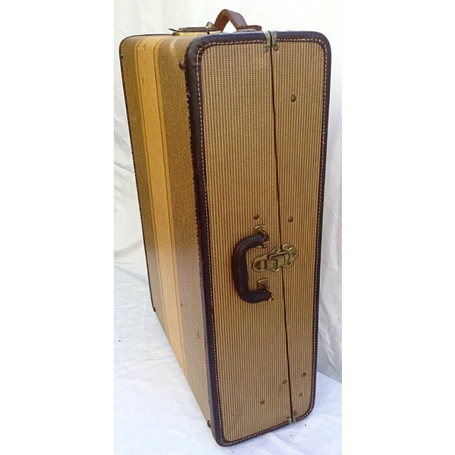Unusual men's luggage piece with interior fitted with extension arms for hanging items, and fitted boxed areas for formal...
