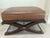 Baker Spanish Savonarola style bench with brown leather top over an X-form base, 20th Century. Height: 19 in. Width: 32...