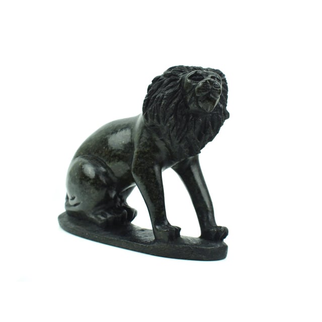 Bring the majesty of the Savannah into your home with this stunning handcrafted solid stone sitting lion figurine on base....