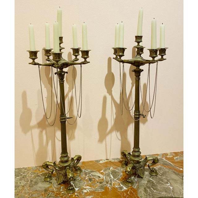 A pair of French empire bronze candelabrum from the early 19th century, about 1815. All chains are intact and these are in...